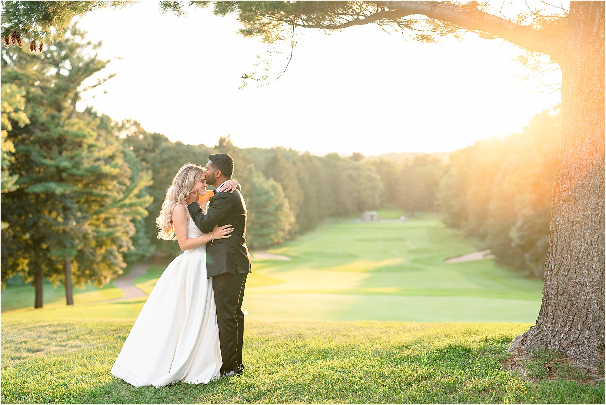Leah and Anosh overlooking the hills at Pine Knob Mansion during sunset on their wedding day.